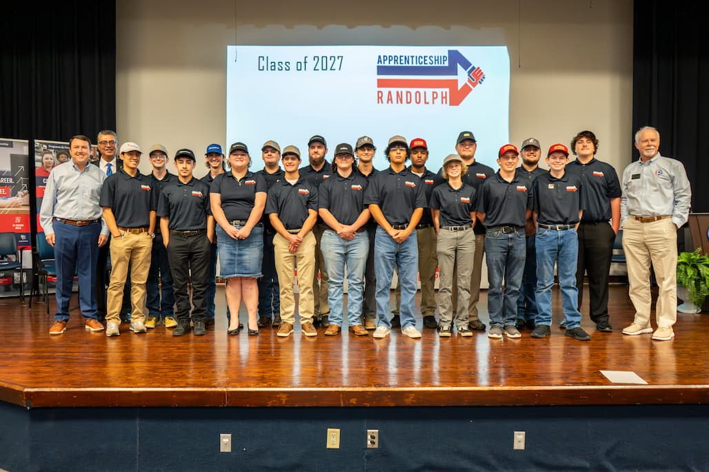 Photo of a large group of people standing on a stage.