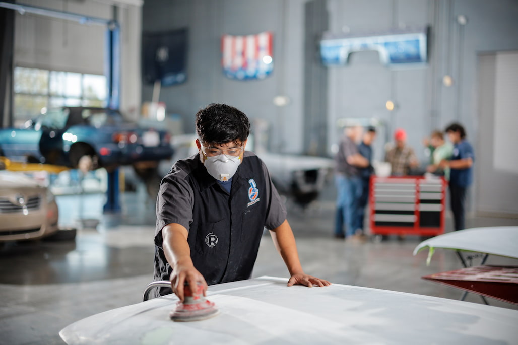 Photo of a Collision Repair and Refinishing Technology student prepping a car for painting.