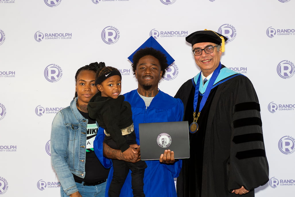 Photo of a graduate with RCC President/CEO Dr. Shah Ardalan and his family.