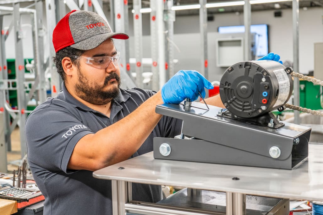 Photo of a person working on a machine.