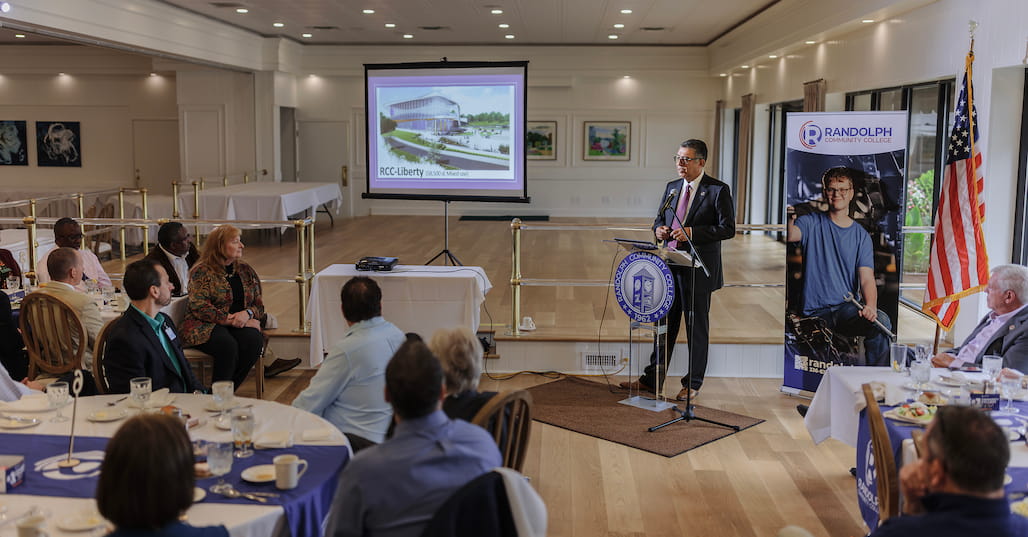 Photo of Randolph Community College President/CEO Dr. Shah Ardalan presenting a PowerPoint to a group of people at Pinewood Country Club.