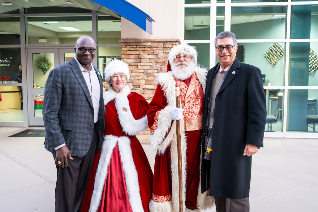 Photo of Randolph Community College President/CEO Dr. Shah Ardalan and Trustee Alvin Battle, left, pose with Santa and Mrs. Claus at the annual Tree Lighting Ceremony, held Tuesday, Dec. 3, on the Asheboro Campus.