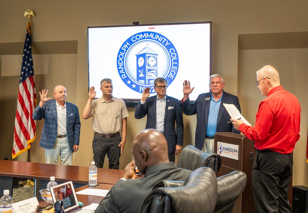 Photo of four people being sworn in.