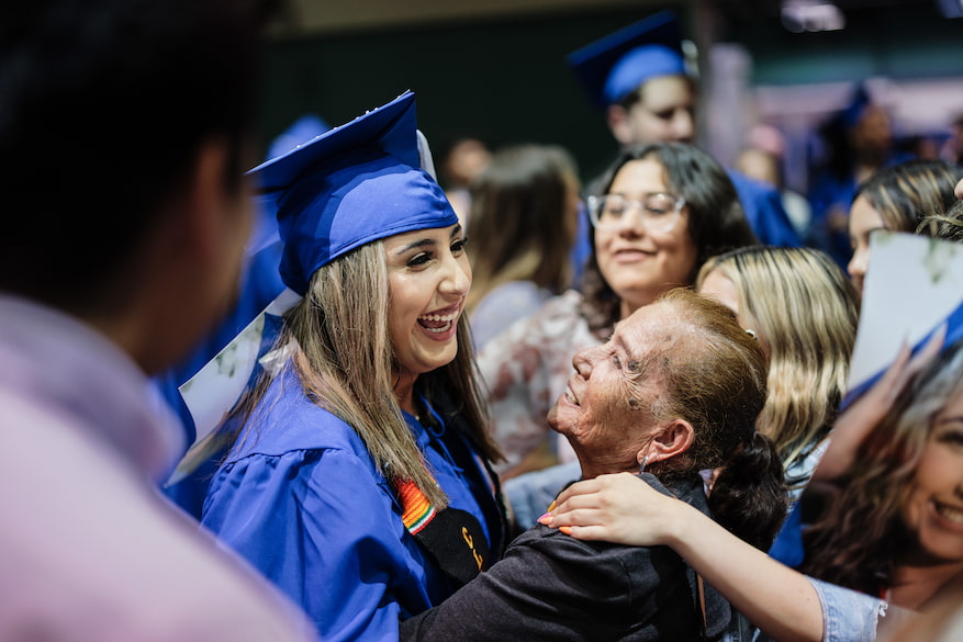 Photo of a graduate celebrating with their family.